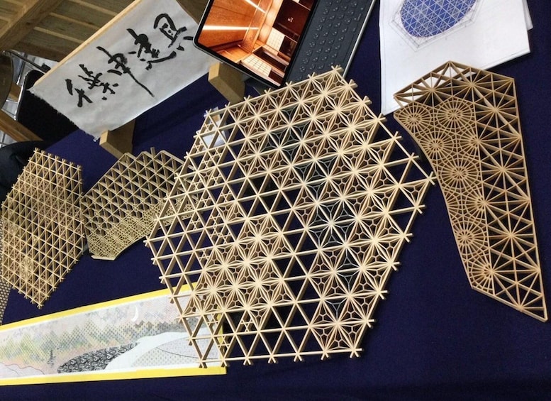 A collection of wooden lattice structures and architectural models on display. 5