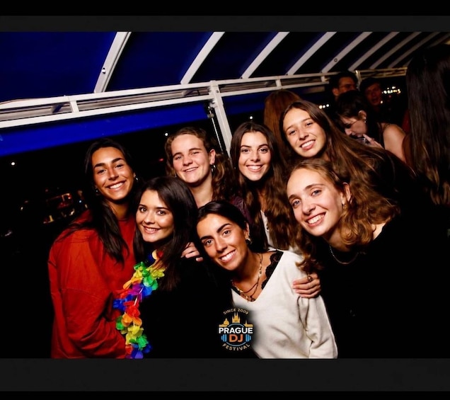 A group of people at a social event, possibly a festival, with a logo indicating it's the Prague DJ Festival. 4