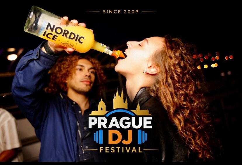 A person holding a bottle labeled 'Nordic Ice' at the Prague DJ Festival. 2