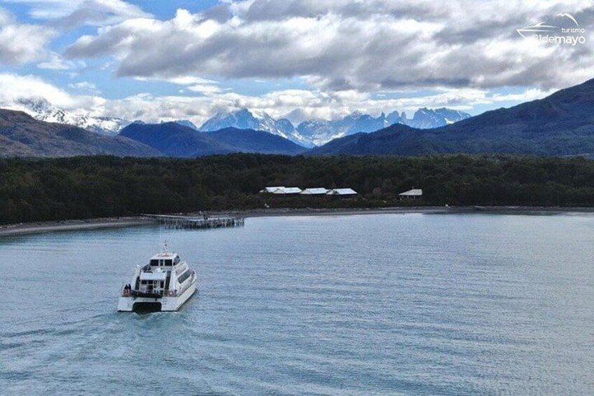 A boat on calm water with mountains in the background. 3