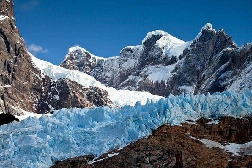 A glacier with rugged mountains in the background. 4