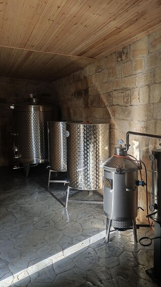 A brewery with stainless steel tanks and a wooden ceiling. 1