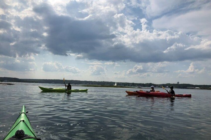 Three kayaks on calm water with a cloudy sky. 2