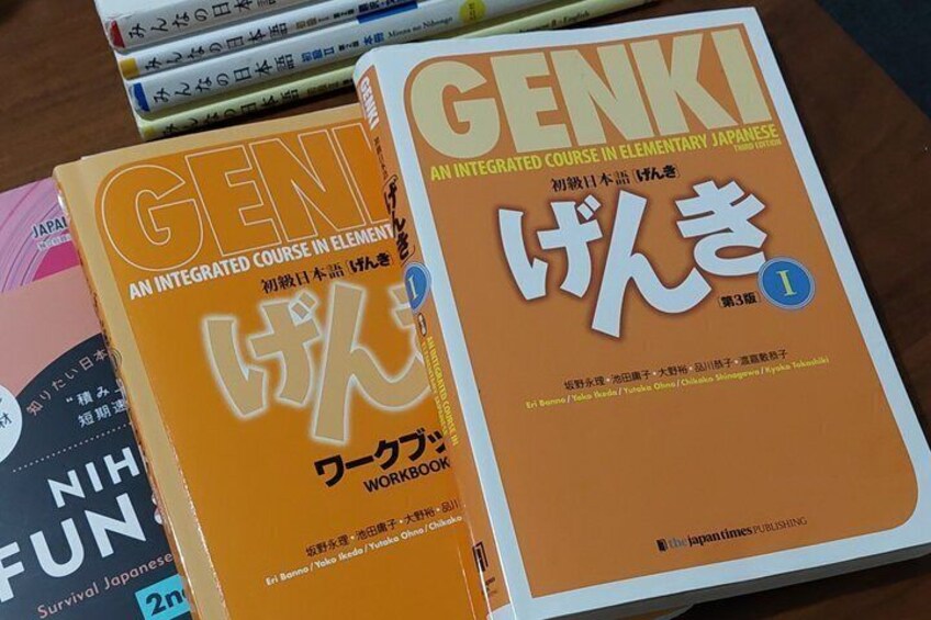 A collection of Japanese language learning books on a table. 2