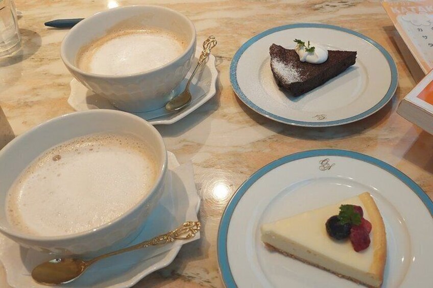 Two cups of coffee and two plates of dessert. 4