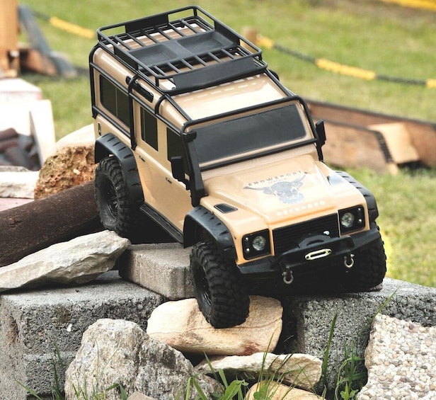 A toy off-road vehicle on rocks. 4