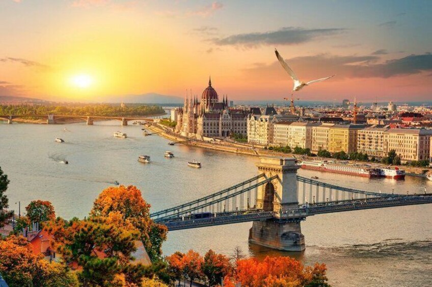 A river with boats, a bridge, and a cathedral. 2