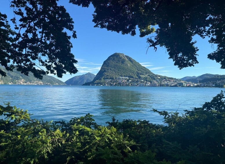 A lake with a prominent mountain in the background and surrounding greenery. 2
