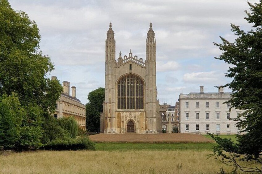 A historic building with a large arched window and two tall towers. 1