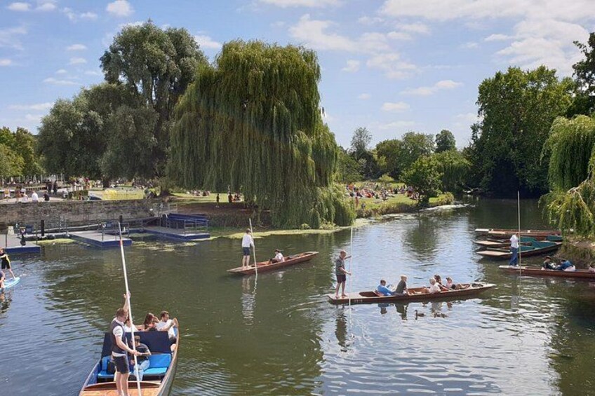 A river with boats, people, and trees. 3
