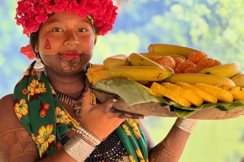 A person holding a tray with bananas, oranges, and mangoes. 4