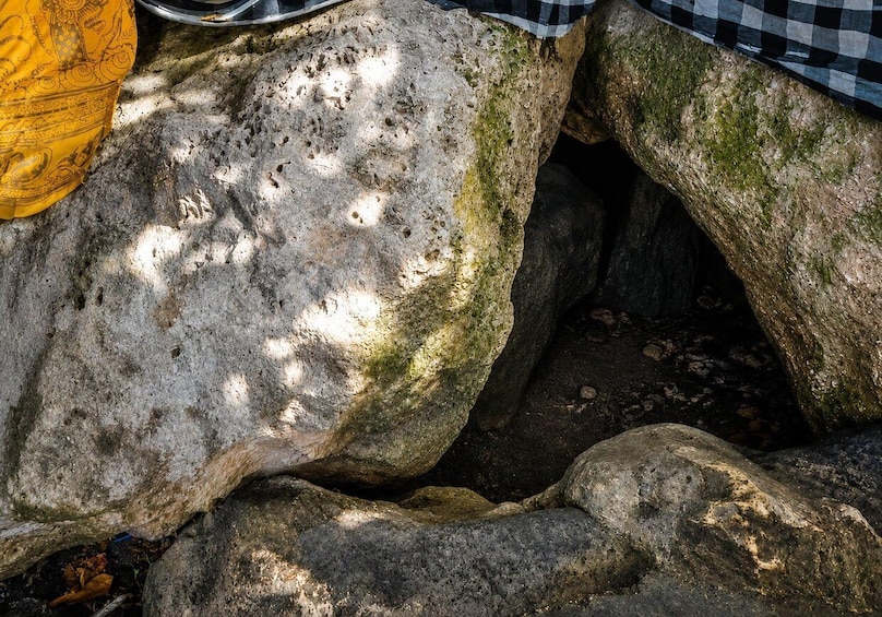 A large rock with a checkered cloth draped over it. 5