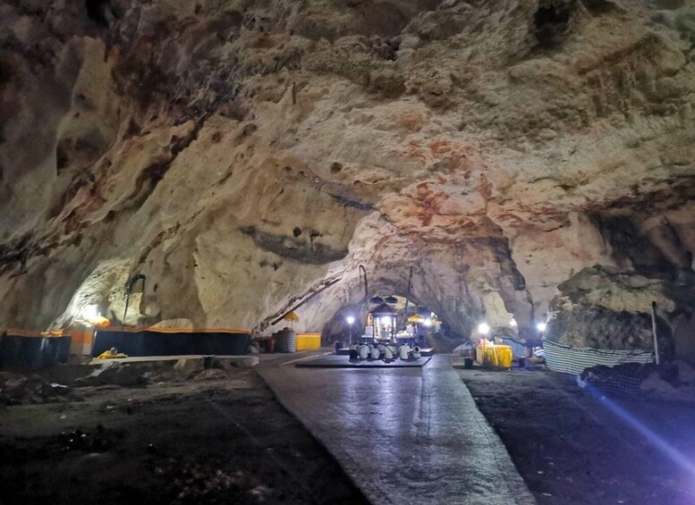 A cave with a central tunnel and artificial lighting. 4