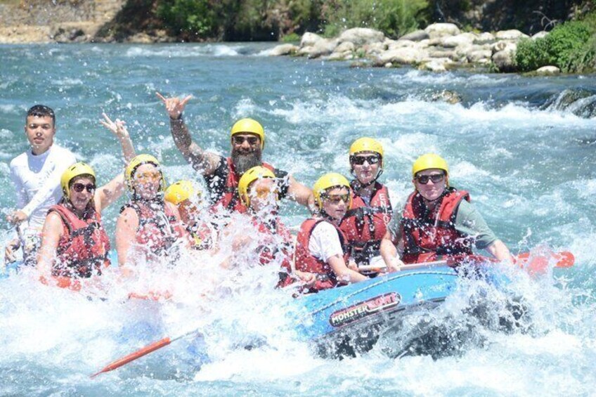 A group of people in a raft navigating a river. 5