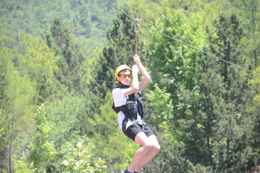 A person zip-lining through a forested area. 3