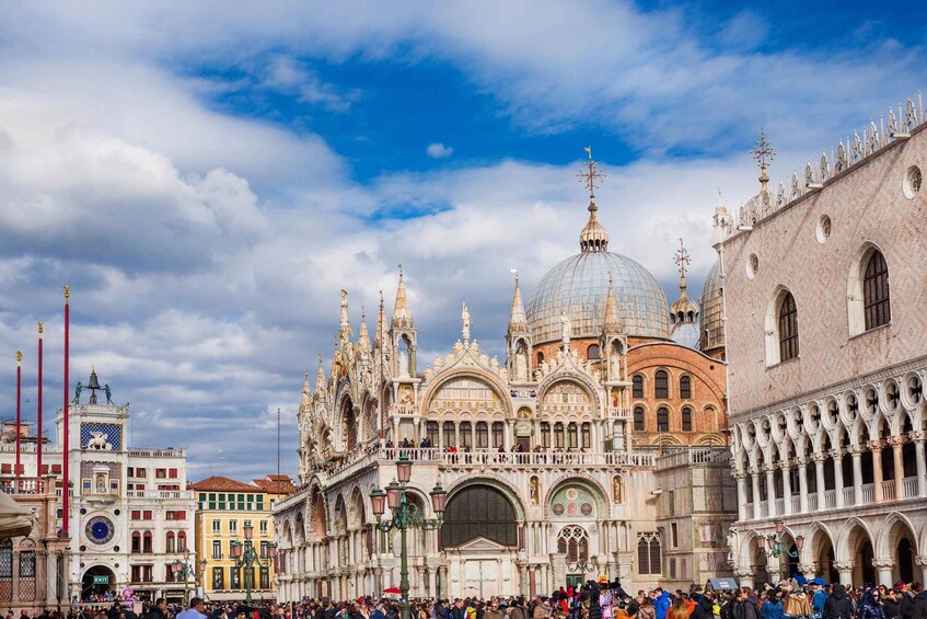 A historic square with ornate buildings, including a prominent church with a large dome and intricate facades. 4