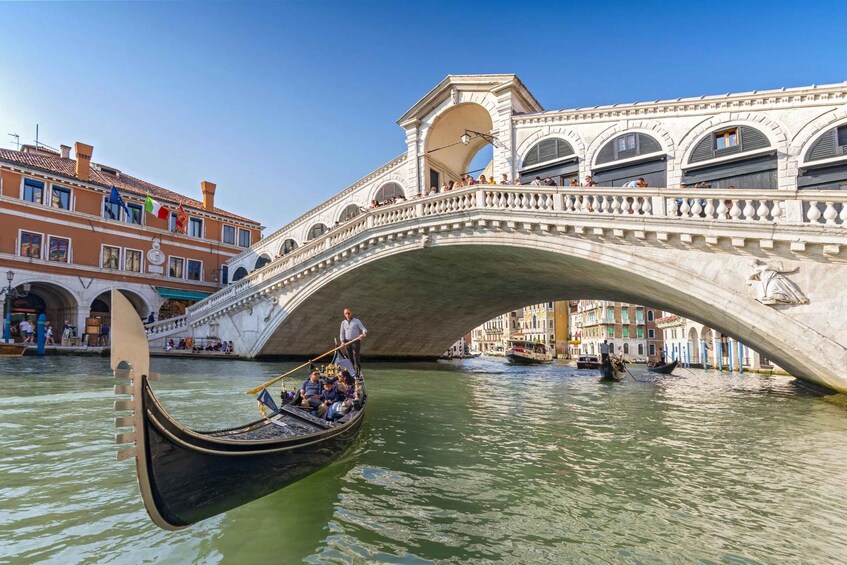 A gondola under a bridge in Venice. 3