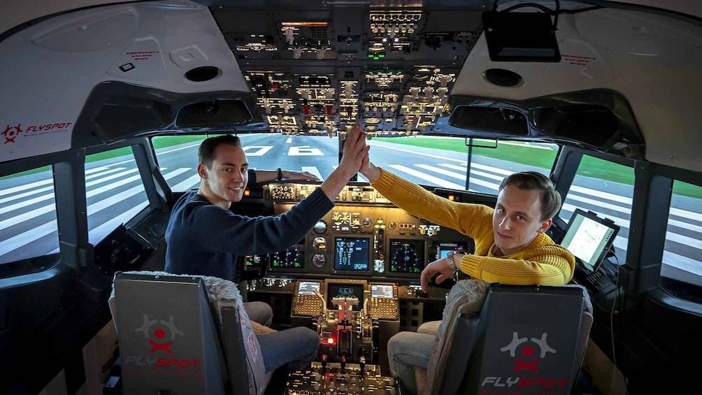 A cockpit with two pilots, emergency escape rope, and multiple control panels. 1