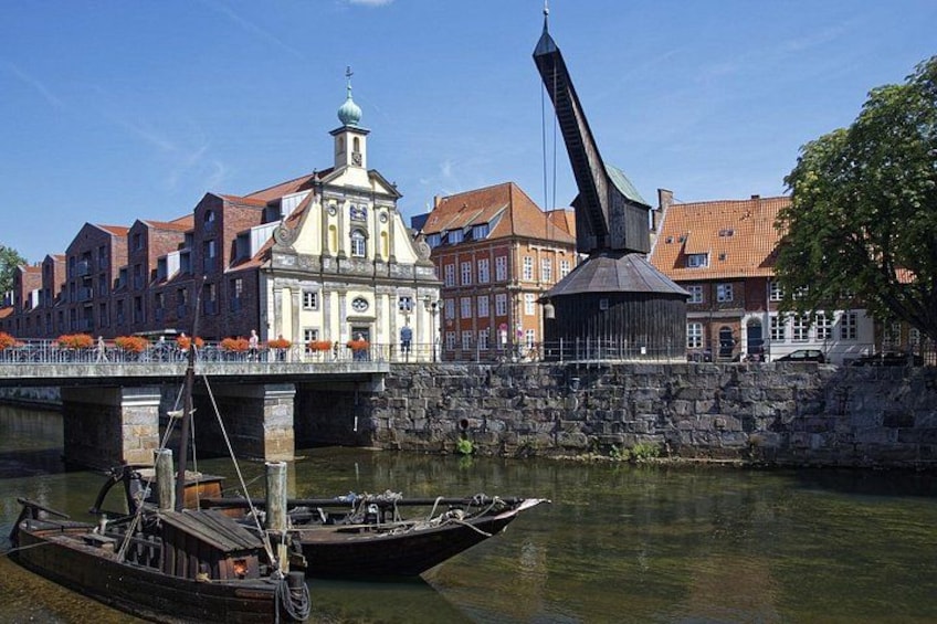 A river with boats, a bridge, and historic buildings. 1
