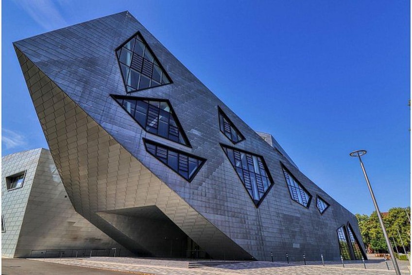 A modern building with a unique angular design and large windows. 3