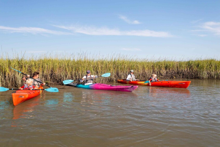 People in kayaks on a calm river. 5