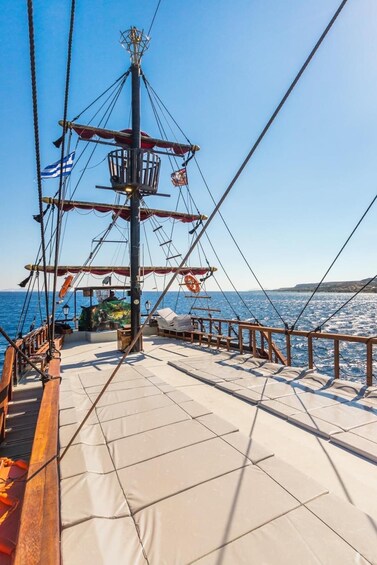 A ship's deck with a clear view of the sea and distant land. 1