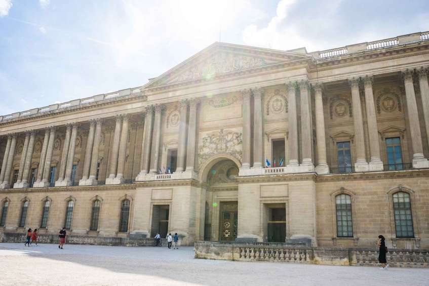 A large classical building with columns and a central pediment. 3