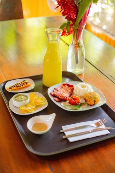 A tray with breakfast items including toast, eggs, rice, and a beverage. 3