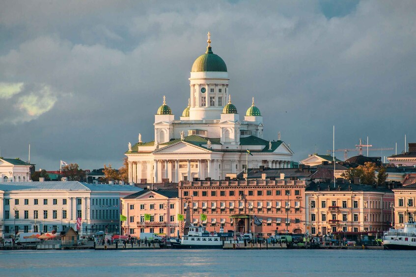 A large white building with a green dome and multiple smaller domes, surrounded by other historic buildings. 2