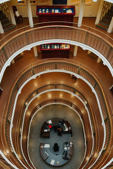 A multi-level atrium with a central seating area and a display case on the upper level. 5