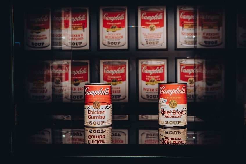 A display of Campbell's soup cans in a refrigerated case. 1