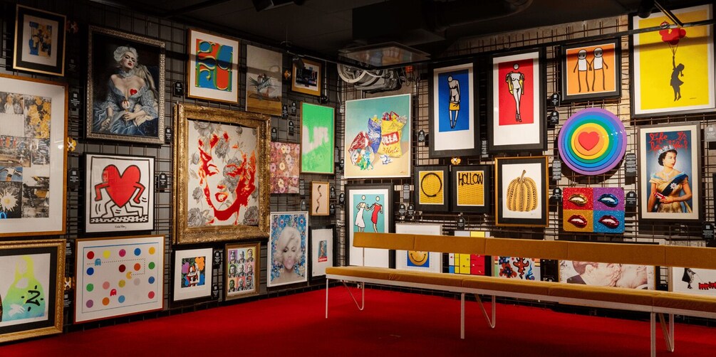 A gallery with various framed artworks on display. 2