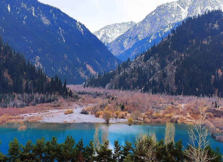 A mountain landscape with a clear lake and surrounding forest. 2
