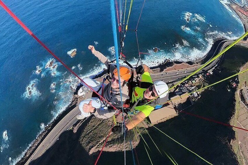 A group of people bungee jumping from a bridge over a coastal area. 2