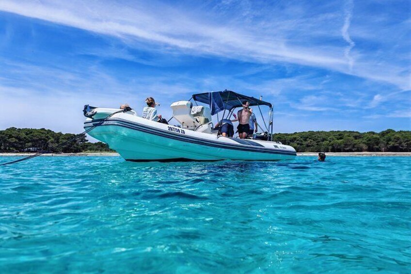 A boat on turquoise water with a clear sky. 3