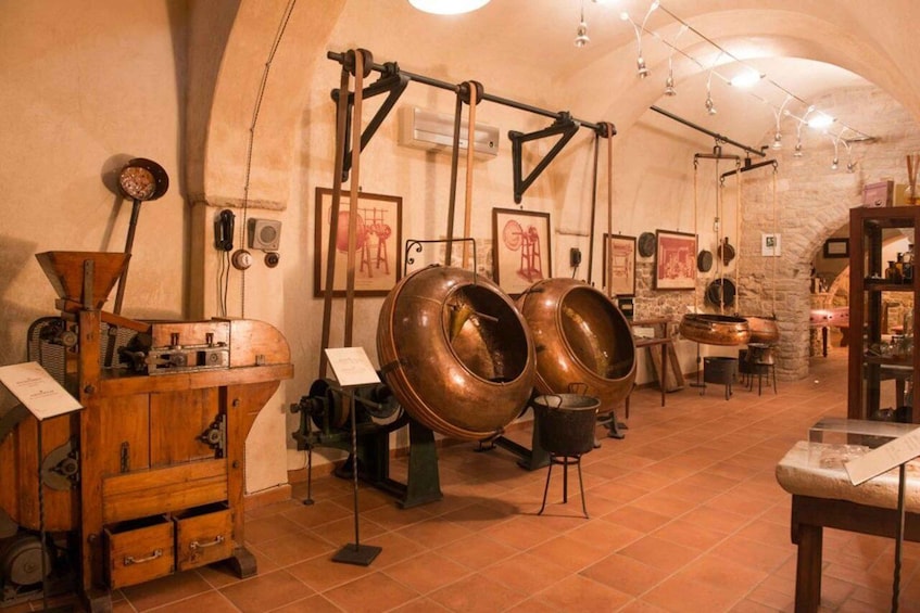 An interior with vintage brewing equipment, copper stills, and rustic decor. 1