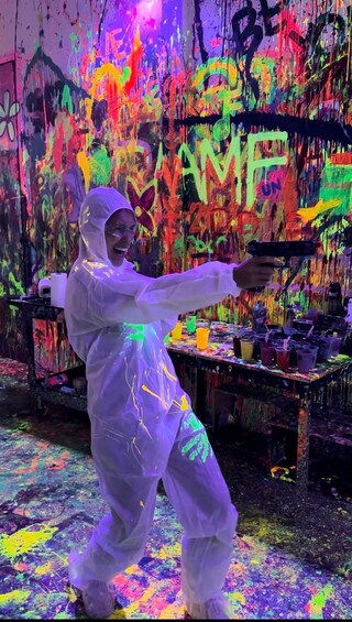 A person in a protective suit painting a wall with vibrant colors. 3
