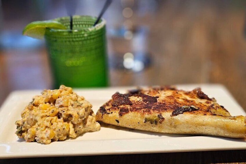 A plate with a slice of pizza and a side of macaroni salad. 3
