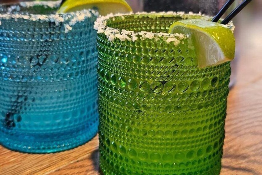 Two textured glasses with lime wedges and straws. 2