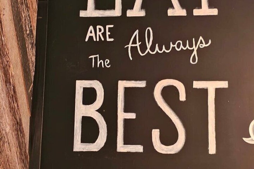 A sign with the words 'LIFE ARE ALWAYS THE BEST' in large, white letters on a dark background. 5