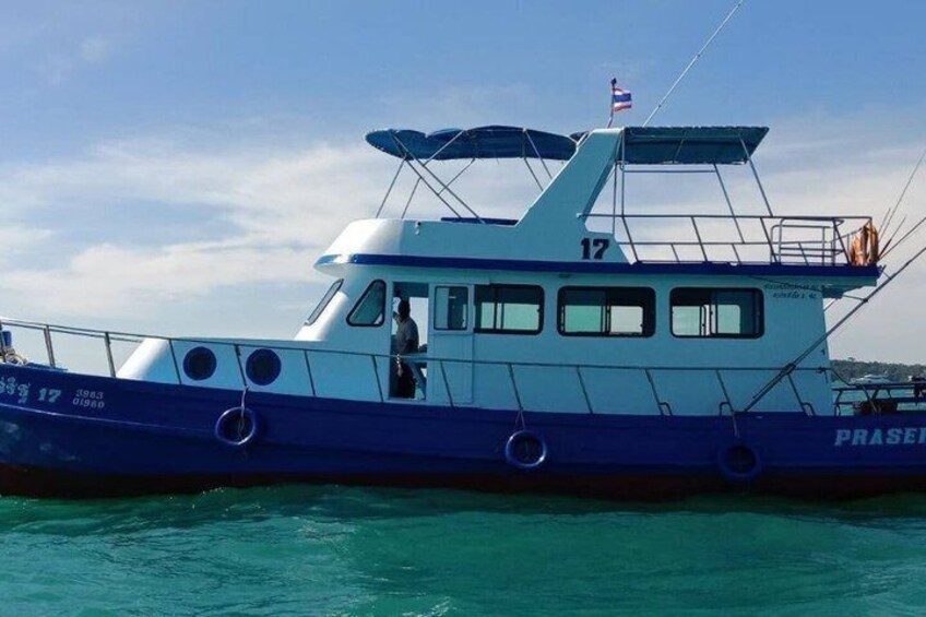 A blue and white boat with the number 17 on the deck, named PRASER, floating on calm water. 3