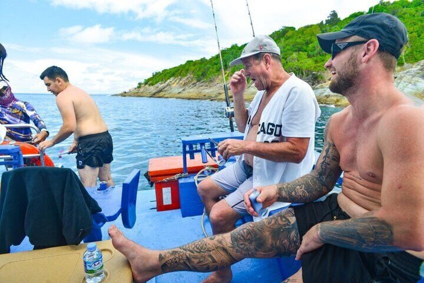 People on a boat with a water body and greenery in the background. 5