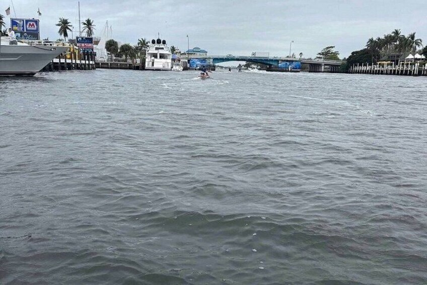 A body of water with a bridge and boats. 4