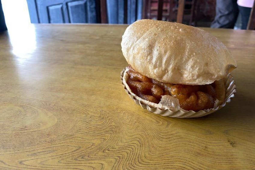 A sandwich on a wooden table. 5