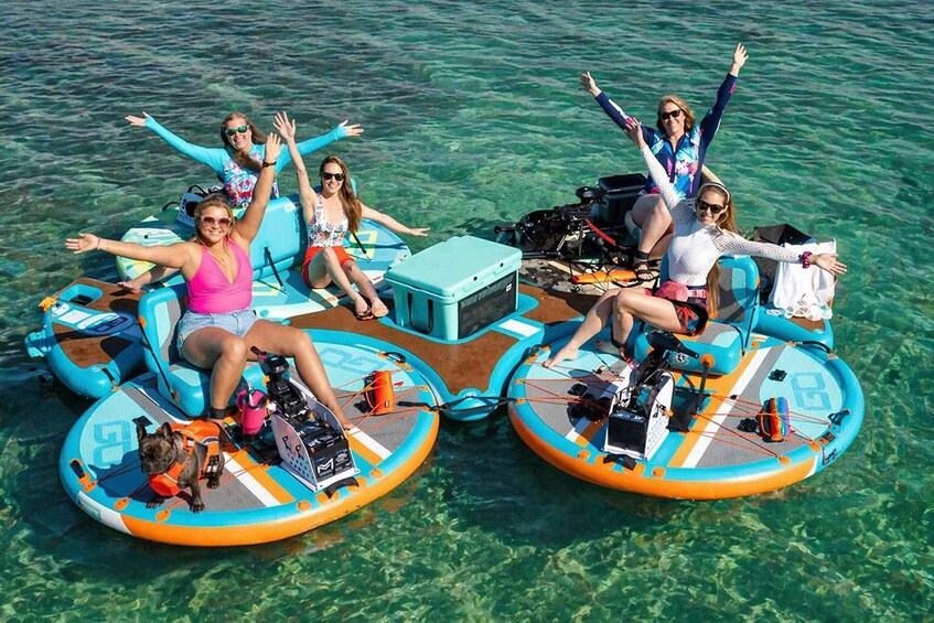 People on inflatable rafts in clear water. 3