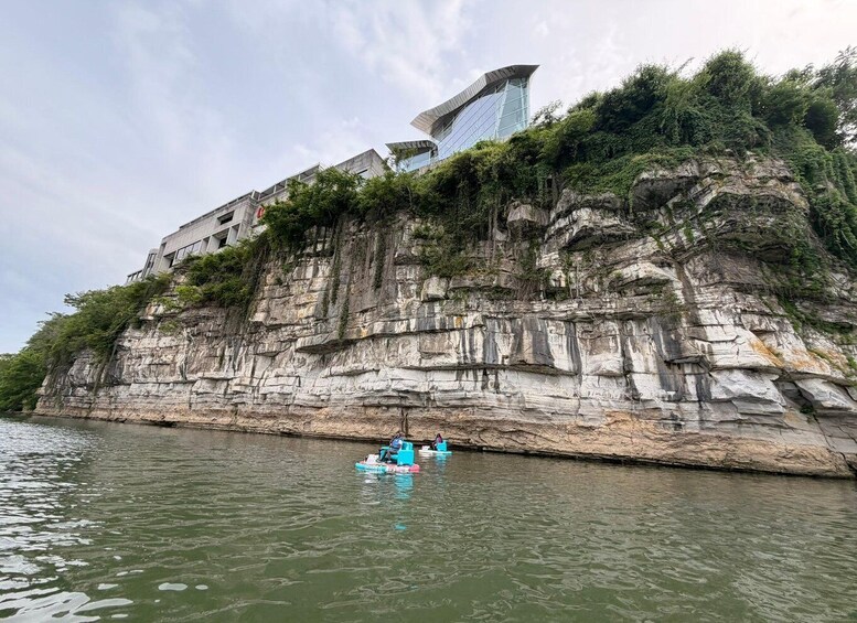 A modern building on a cliff by a river. 4