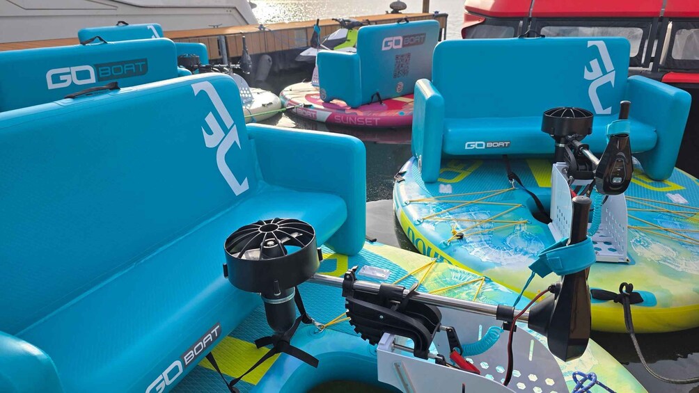 Blue boat seats with 'GO BOAT' branding, a motor, and a colorful inflatable boat. 2