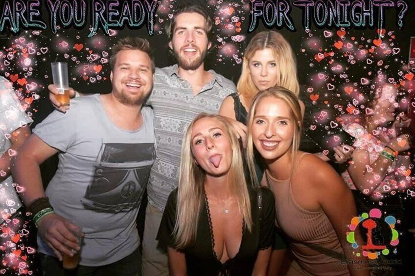 A group of people posing for a photo with a backdrop that includes the text 'ARE YOU READY FOR TONIGHT?' 4