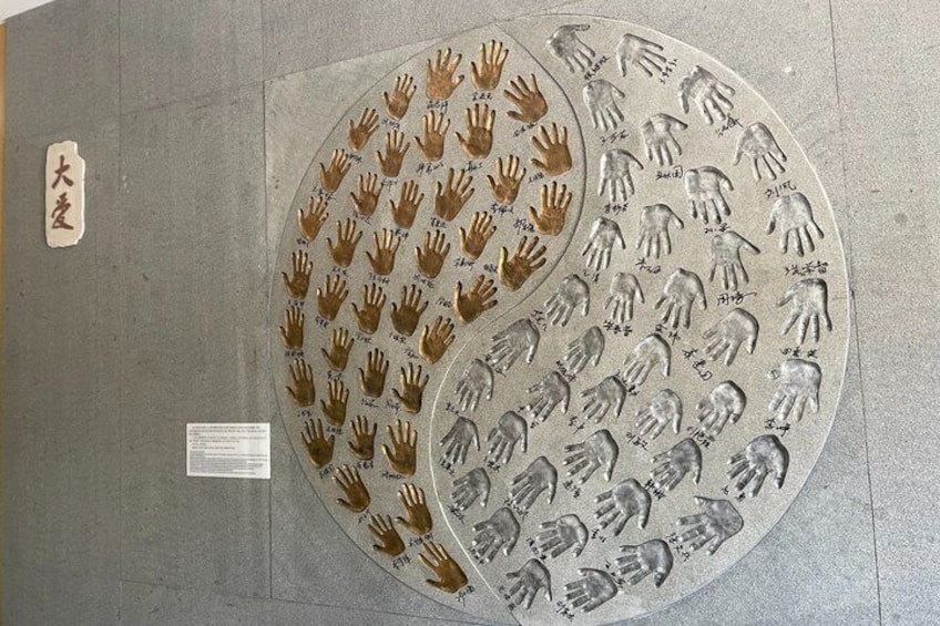 Two circular metal plates with handprints and names on them. 3