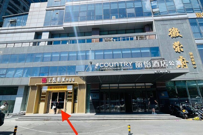 A modern building with a sign for 'Country' and another sign in a different language. 5